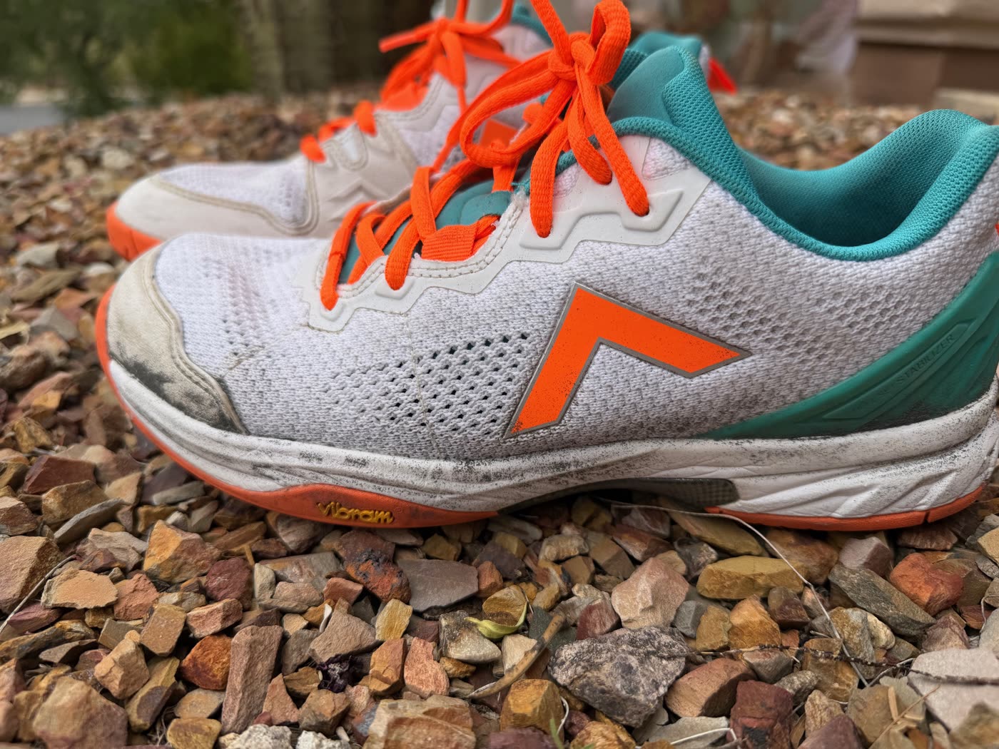 Tyrol Velocity V in white/aqua/orange. Side view showing the Vibram outsole, the orange Tyrol chevron, and the white toe bumper after nearly two years of regular play.